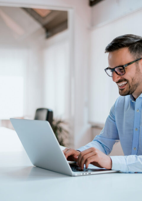 Portrait,Of,Young,Man,Sitting,At,His,Desk,In,The